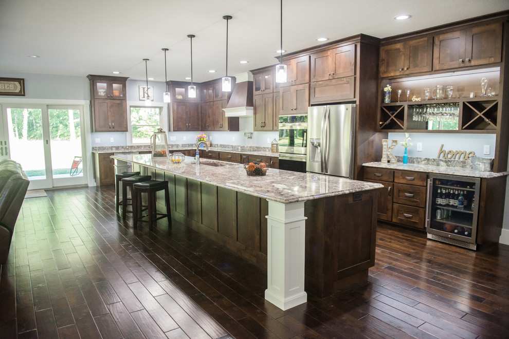 Inspiration for a transitional l-shaped dark wood floor open concept kitchen remodel with an undermount sink, shaker cabinets, dark wood cabinets, granite countertops, stainless steel appliances, an island and multicolored countertops