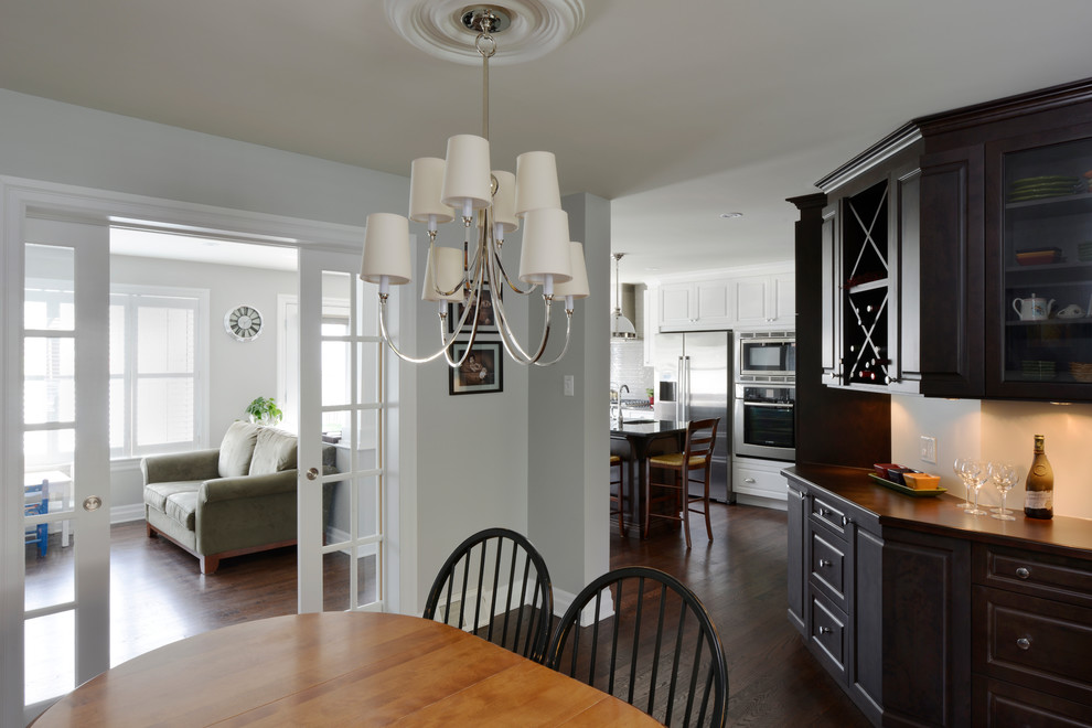 This is an example of a mid-sized transitional kitchen/dining combo in Ottawa with grey walls, dark hardwood floors and no fireplace.