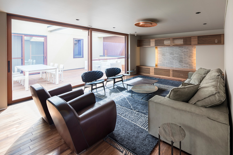 Design ideas for a modern formal enclosed living room in Yokohama with medium hardwood floors, brown floor and beige walls.