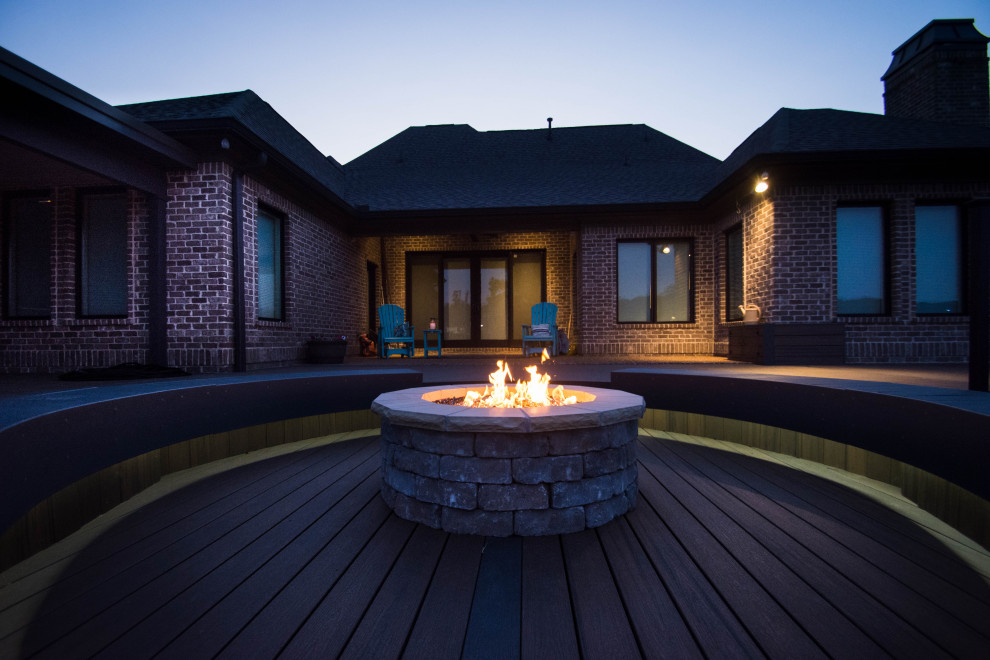 Inspiration for a large transitional backyard deck remodel with a fire pit and no cover