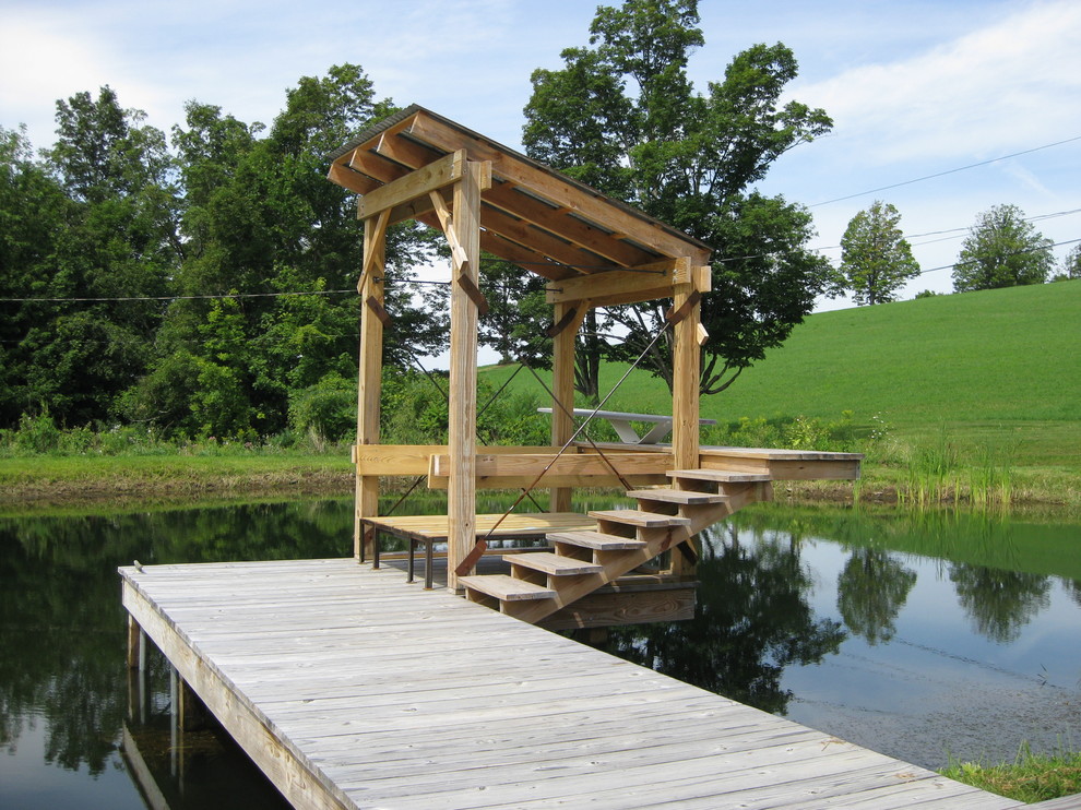 Photo of a country deck in New York with a water feature.