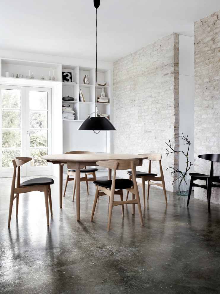 Inspiration for an industrial dining room in New York with concrete floors.