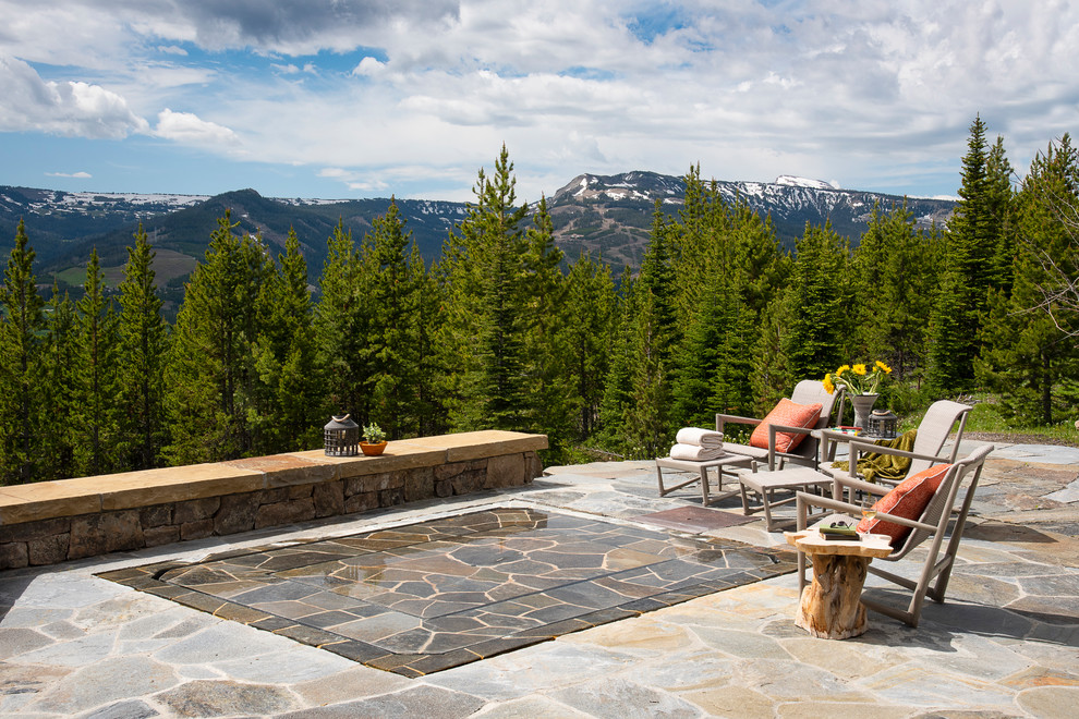 Inspiration for a large country backyard rectangular pool in Other with a hot tub and natural stone pavers.