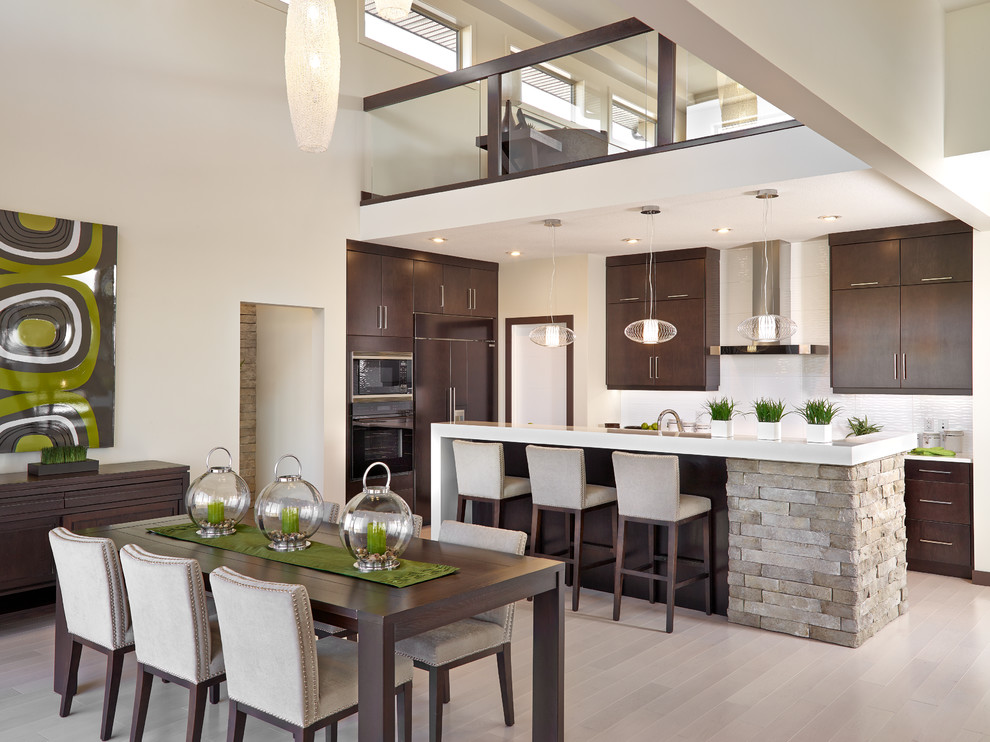 Photo of a contemporary kitchen/dining combo in Calgary with beige walls, light hardwood floors and no fireplace.