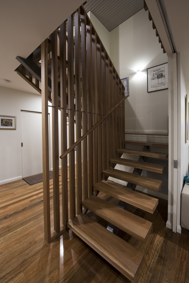 Inspiration for a contemporary wood floating staircase in Newcastle - Maitland with open risers.