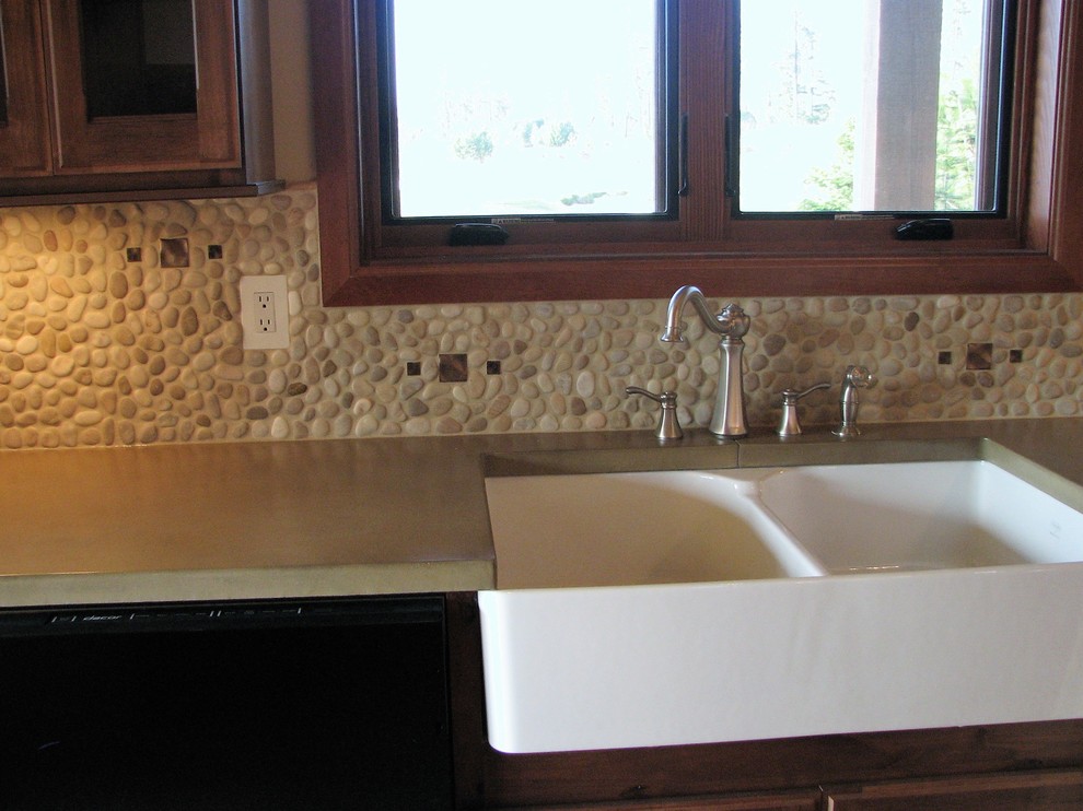 Large mountain style u-shaped medium tone wood floor and brown floor open concept kitchen photo in Seattle with a farmhouse sink, beaded inset cabinets, distressed cabinets, concrete countertops, beige backsplash, stone tile backsplash, stainless steel appliances and an island