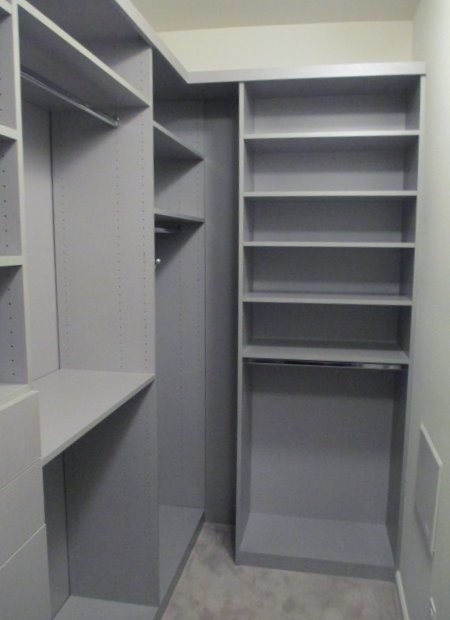 Inspiration for a small modern gender-neutral walk-in wardrobe in Los Angeles with flat-panel cabinets, grey cabinets, carpet and beige floor.