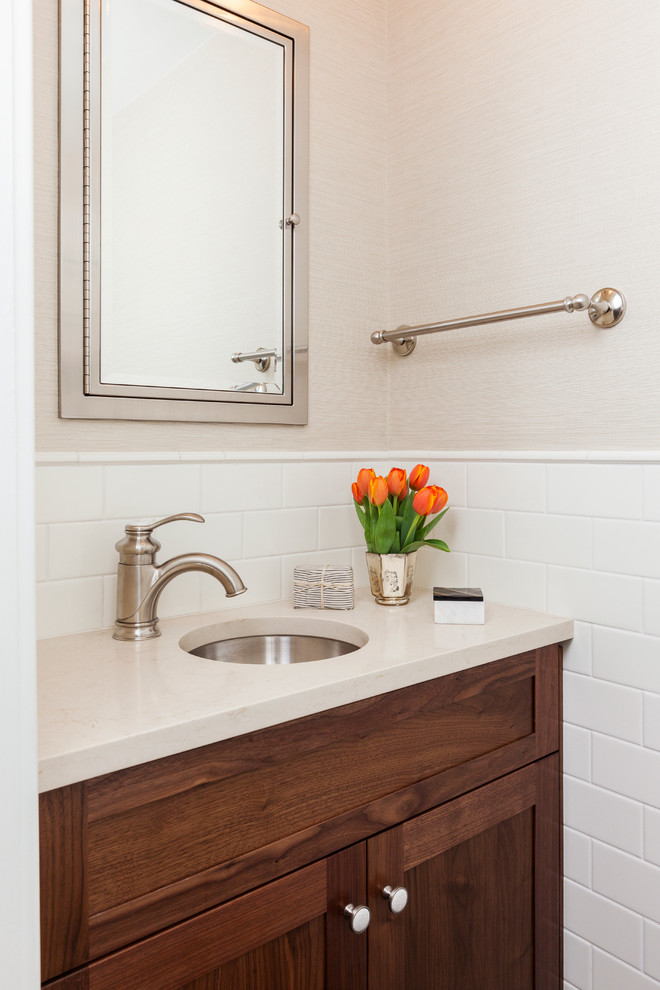 Design ideas for a small traditional bathroom in Philadelphia with an undermount sink, recessed-panel cabinets, medium wood cabinets, engineered quartz benchtops, an alcove tub, a two-piece toilet, white tile, ceramic tile, beige walls and porcelain floors.