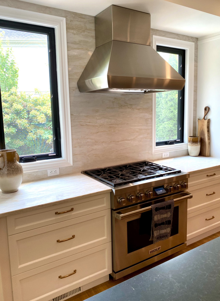 Example of a large transitional l-shaped light wood floor open concept kitchen design in Toronto with an undermount sink, recessed-panel cabinets, white cabinets, quartz countertops, paneled appliances and an island
