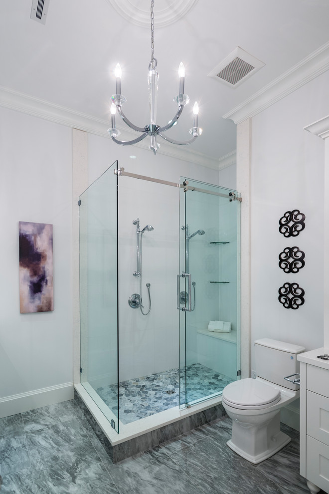 Huge mountain style 3/4 white tile and stone tile marble floor and gray floor corner shower photo in Vancouver with shaker cabinets, white cabinets, a two-piece toilet, white walls, an undermount sink, solid surface countertops and white countertops