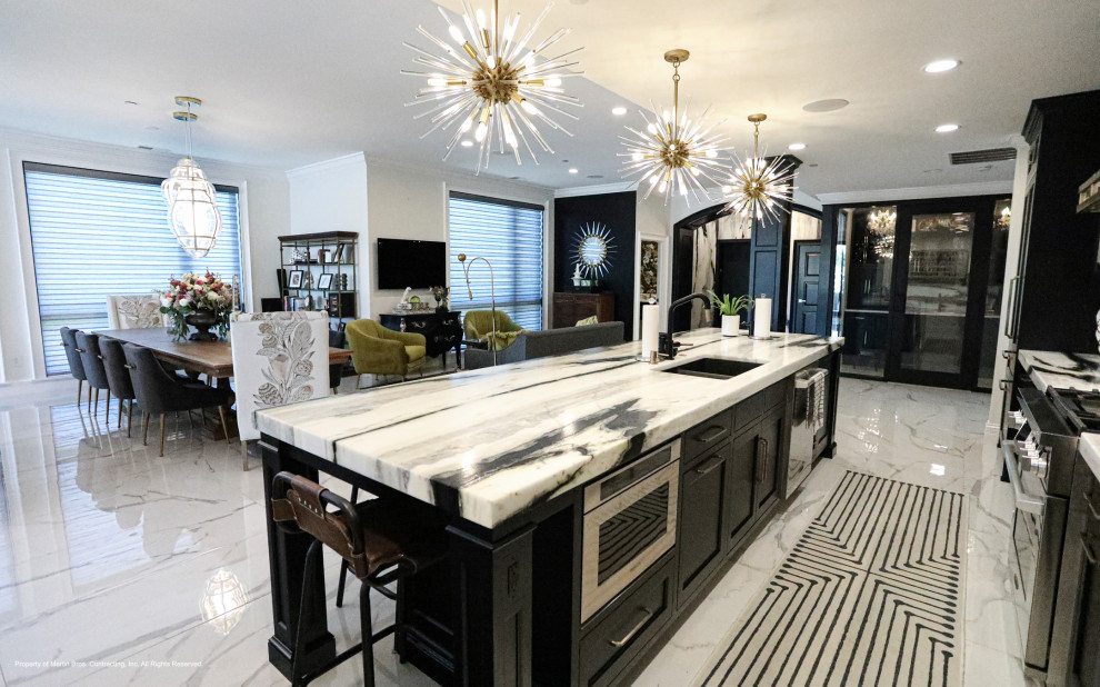 Inspiration for a mid-sized transitional porcelain tile and white floor open concept kitchen remodel with an undermount sink, recessed-panel cabinets, black cabinets, marble countertops, marble backsplash, stainless steel appliances and an island