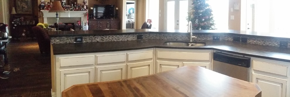 Example of a large transitional brown floor open concept kitchen design in Dallas with an undermount sink, raised-panel cabinets, white cabinets, granite countertops, gray backsplash, stone tile backsplash, stainless steel appliances and an island