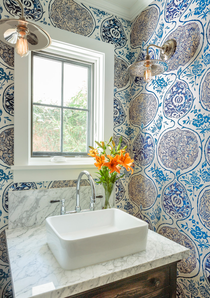 Small country powder room in Los Angeles with blue walls, a vessel sink and marble benchtops.