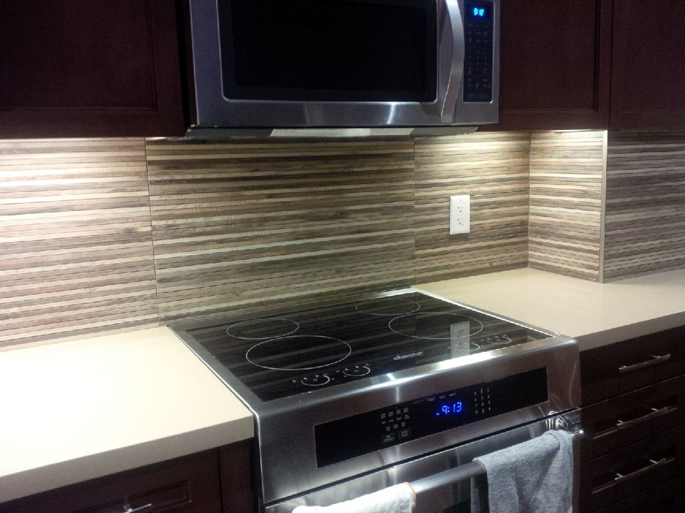 Eat-in kitchen - mid-sized transitional l-shaped dark wood floor and brown floor eat-in kitchen idea in Toronto with a double-bowl sink, shaker cabinets, dark wood cabinets, quartz countertops, brown backsplash, porcelain backsplash, white appliances and an island