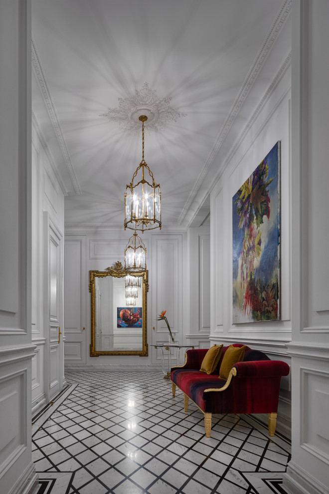 Immagine di un grande ingresso o corridoio classico con pareti bianche, pavimento in marmo, pavimento bianco, soffitto a cassettoni e pannellatura