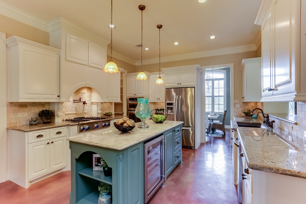 Mid-sized transitional u-shaped concrete floor and brown floor enclosed kitchen photo in Houston with an undermount sink, raised-panel cabinets, white cabinets, granite countertops, beige backsplash, stone tile backsplash, stainless steel appliances and an island