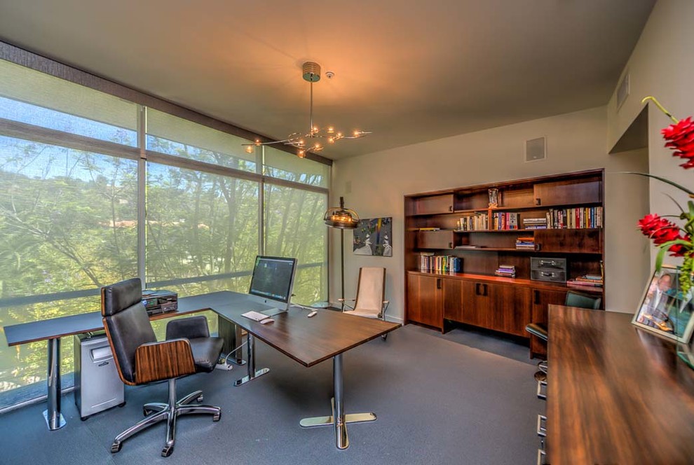 Photo of a large contemporary home office in Los Angeles with beige walls, carpet and a freestanding desk.