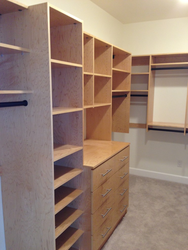Mid-sized contemporary men's walk-in wardrobe in Seattle with medium wood cabinets and carpet.