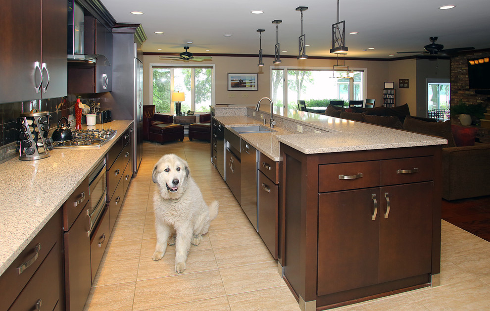 Large transitional galley ceramic tile open concept kitchen photo in Chicago with an undermount sink, flat-panel cabinets, dark wood cabinets, quartz countertops, gray backsplash, stainless steel appliances, an island and metal backsplash