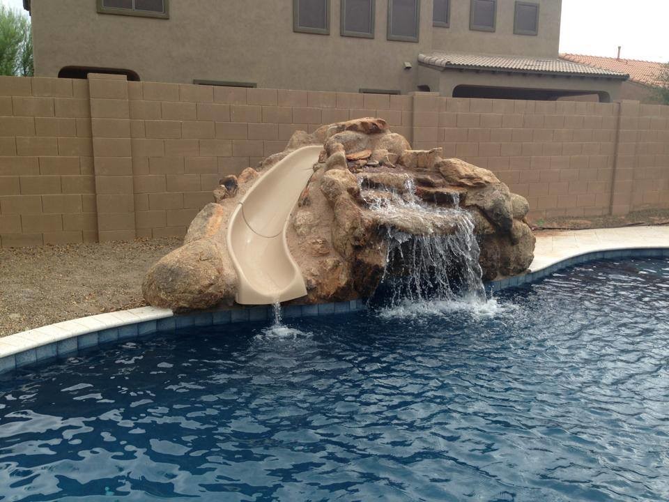 Example of a large backyard tile and kidney-shaped lap water slide design in Phoenix