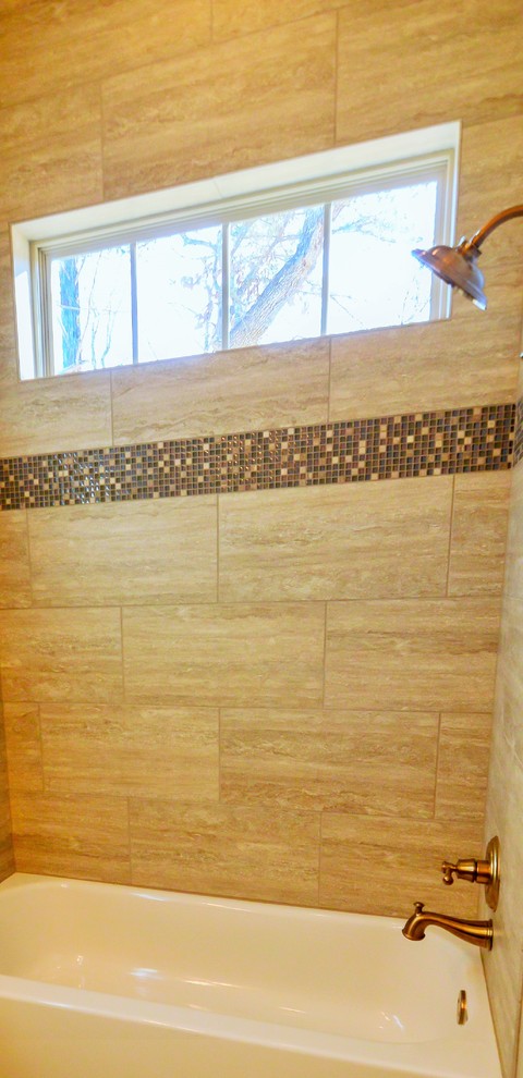 Photo of a large traditional bathroom in Austin with raised-panel cabinets, a drop-in tub, a shower/bathtub combo, beige tile, porcelain tile, beige walls and porcelain floors.