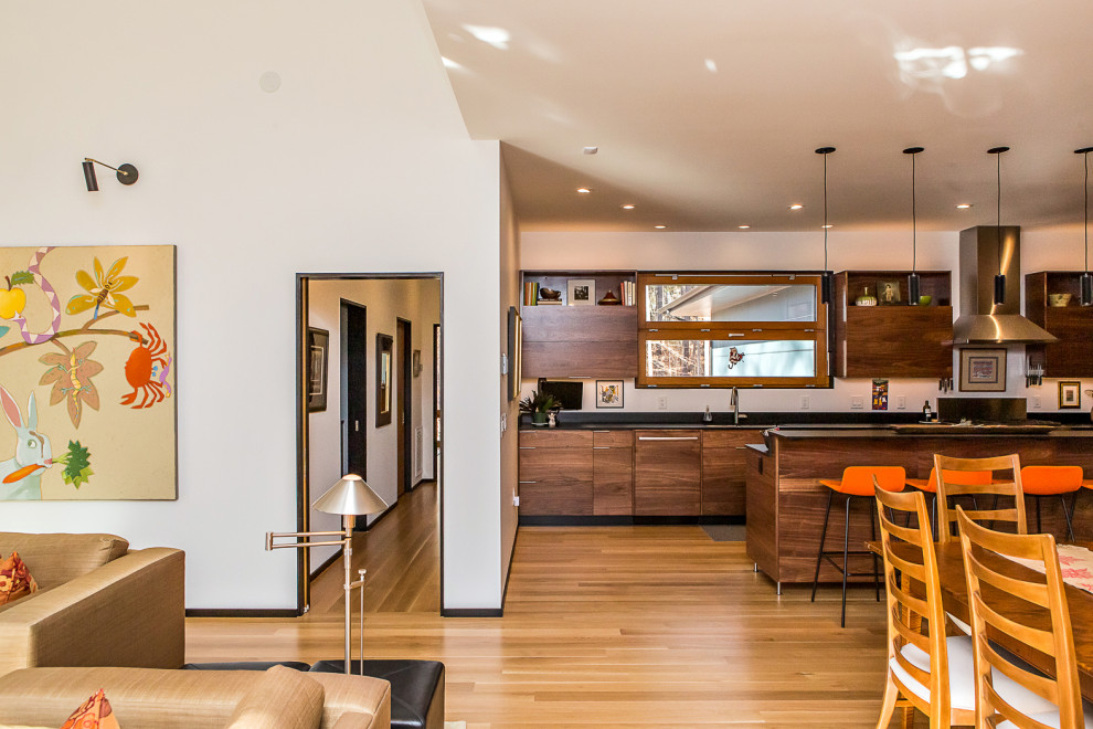 Inspiration for a mid-sized midcentury open concept living room in Raleigh with a home bar, white walls, medium hardwood floors and brown floor.