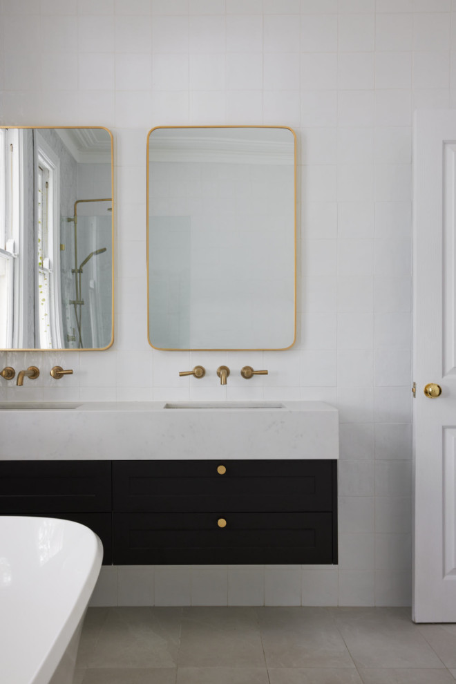 Inspiration for a mid-sized transitional master bathroom in Sydney with shaker cabinets, black cabinets, a freestanding tub, an open shower, a two-piece toilet, white tile, marble, white walls, porcelain floors, a vessel sink, engineered quartz benchtops, grey floor, an open shower, white benchtops, a double vanity and a floating vanity.