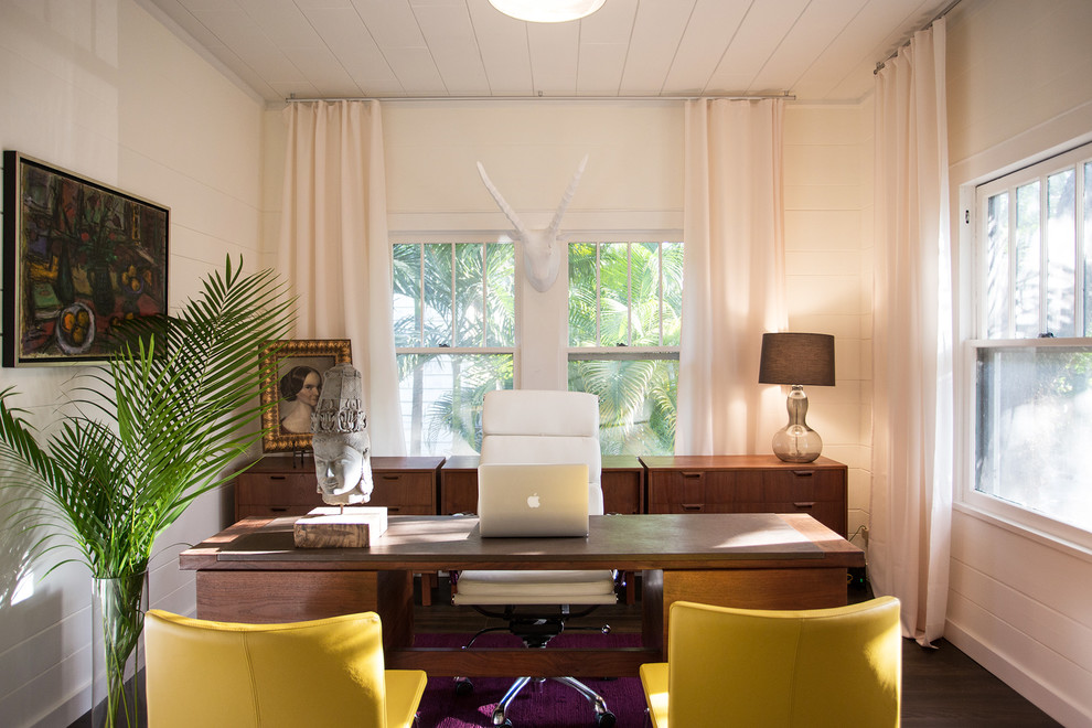 Design ideas for a midcentury study room in Miami with beige walls, dark hardwood floors, a freestanding desk and brown floor.