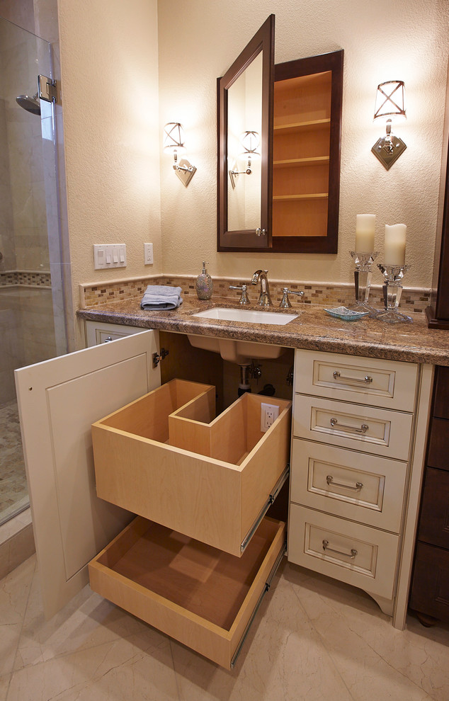 Example of a large classic master beige tile, brown tile and glass tile porcelain tile and beige floor alcove shower design in San Diego with raised-panel cabinets, white cabinets, an undermount tub, beige walls, an undermount sink, granite countertops and a hinged shower door