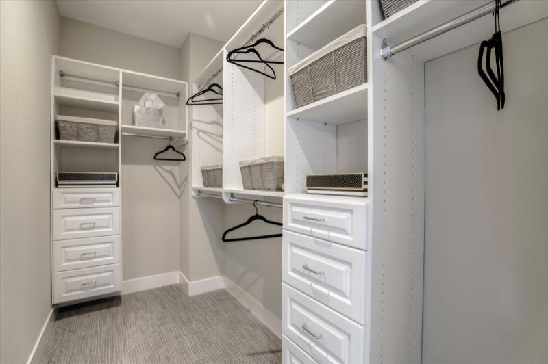 Inspiration for a walk-in wardrobe in San Francisco with raised-panel cabinets and white cabinets.