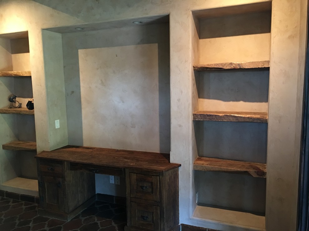 Example of a mountain style built-in desk home design design in Austin with beige walls