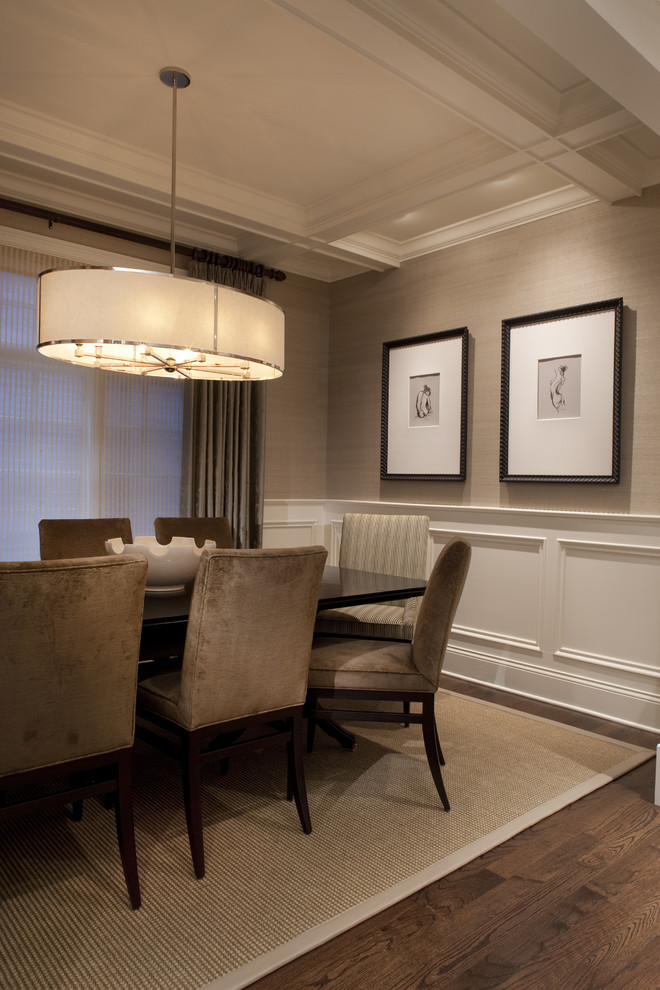 This is an example of a traditional dining room in Chicago with beige walls, dark hardwood floors and brown floor.