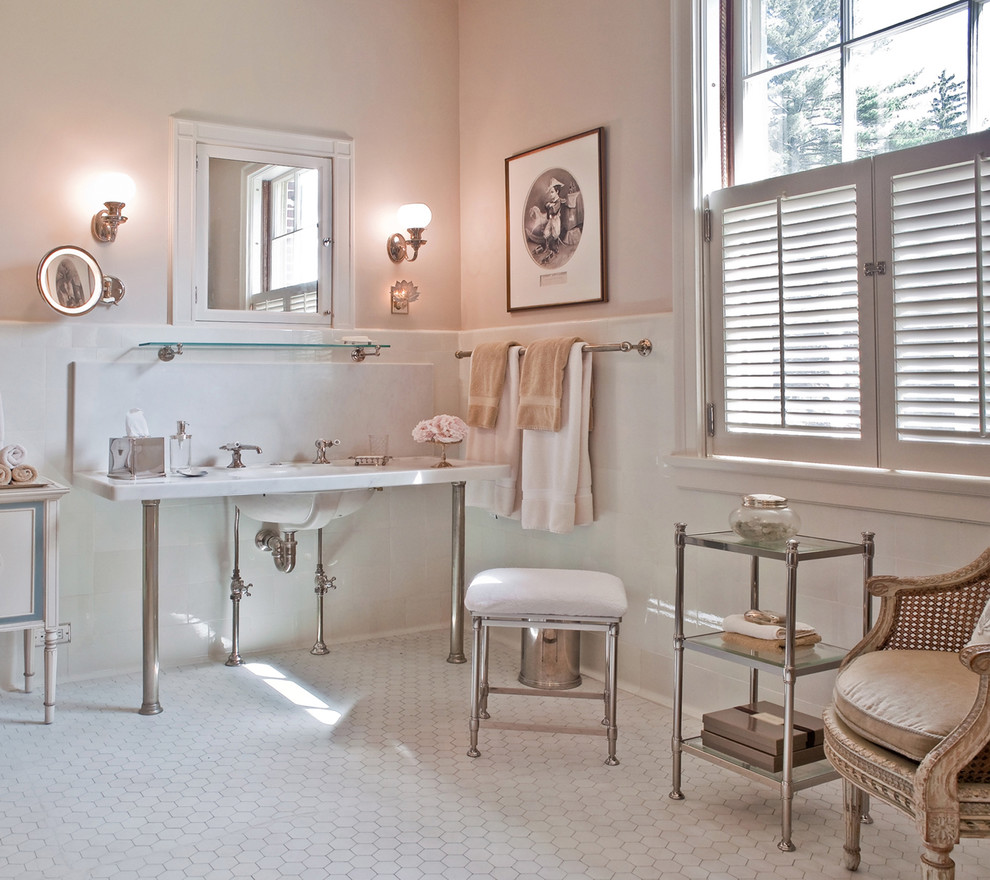 Design ideas for a traditional bathroom in Boston with a console sink, marble benchtops and pink walls.