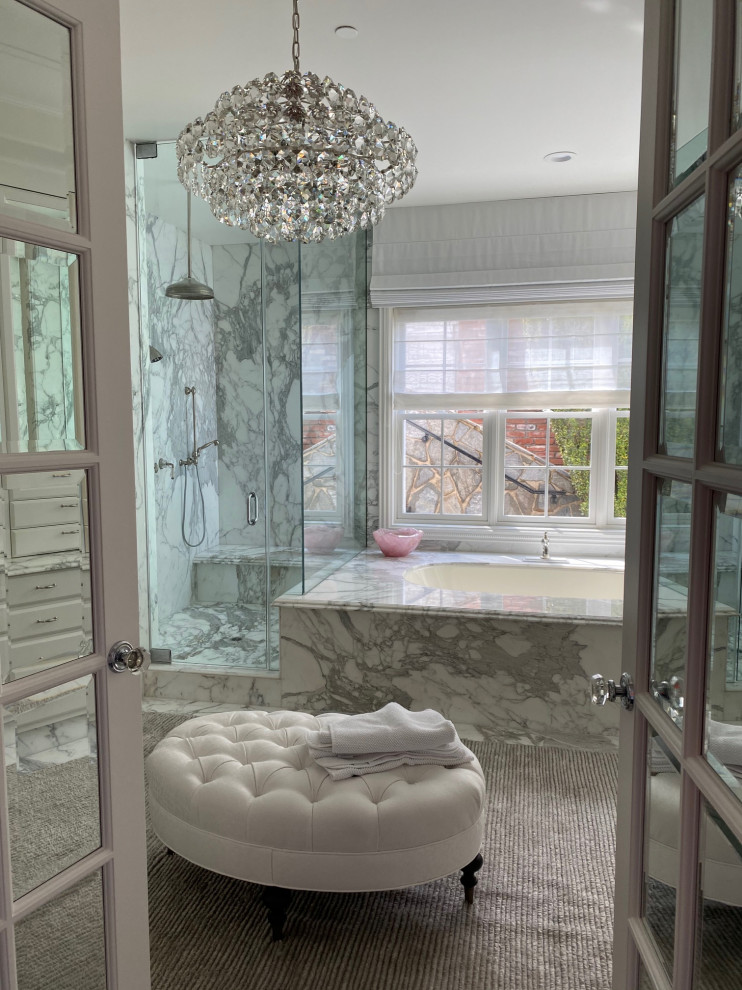 Large master bathroom in Orange County with furniture-like cabinets, white cabinets, a drop-in tub, a corner shower, a two-piece toilet, white tile, marble, white walls, dark hardwood floors, an undermount sink, marble benchtops, brown floor, a hinged shower door, grey benchtops, a shower seat, a double vanity, a built-in vanity, coffered and panelled walls.