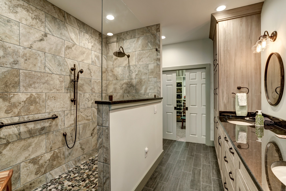 Photo of a large transitional master bathroom in Richmond with recessed-panel cabinets, medium wood cabinets, a curbless shower, brown tile, ceramic tile, ceramic floors, an undermount sink, granite benchtops, brown floor, an open shower, black benchtops, a double vanity and a built-in vanity.
