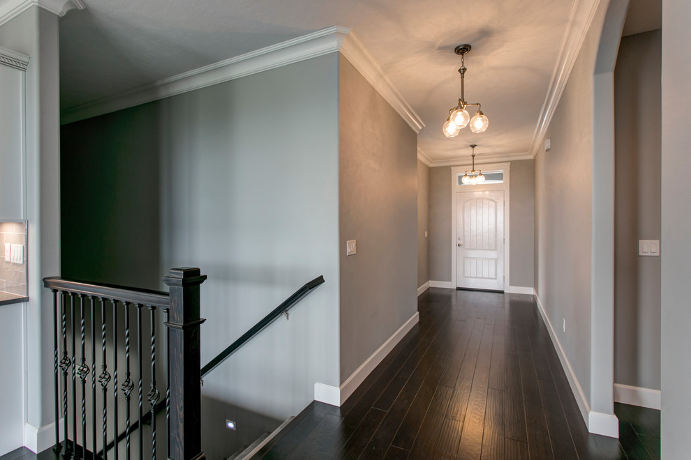 Example of a small transitional dark wood floor entry hall design in Seattle with gray walls and a white front door