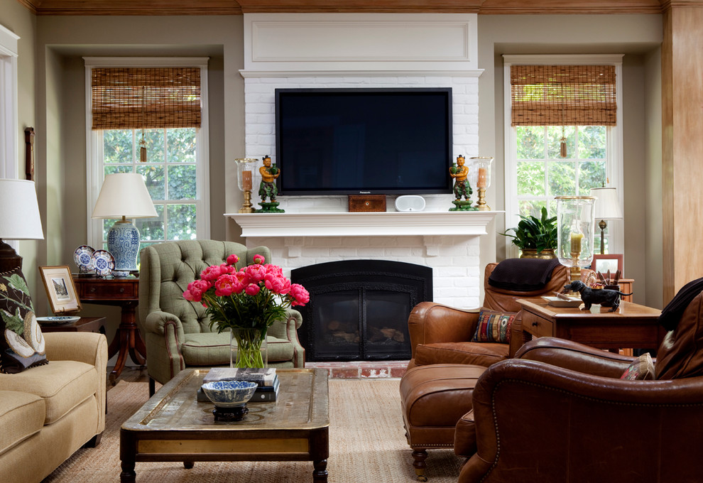 This is an example of a mid-sized traditional family room in San Francisco with beige walls, a standard fireplace, a brick fireplace surround and a wall-mounted tv.