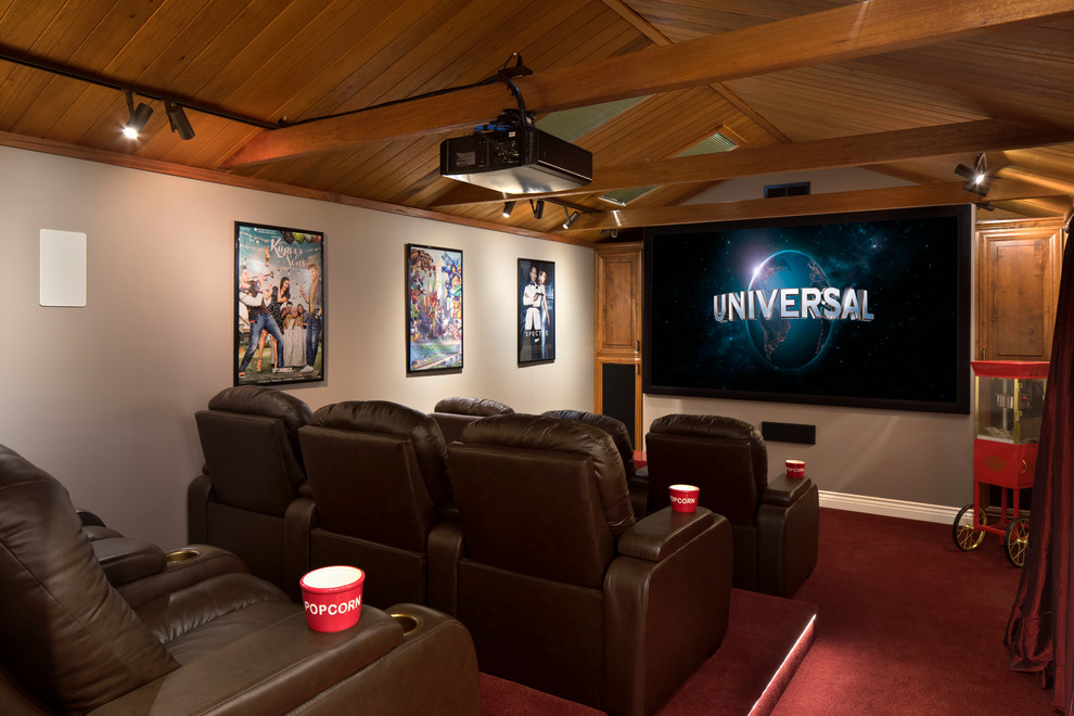 Large mediterranean enclosed home theatre in San Francisco with beige walls, carpet, red floor and a projector screen.