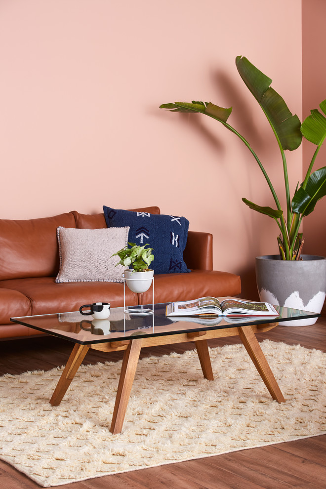 Small contemporary open concept living room in Sydney with pink walls, vinyl floors and brown floor.