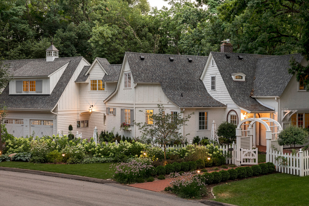 Inspiration for a traditional two-storey white house exterior in Minneapolis with a gable roof and a shingle roof.