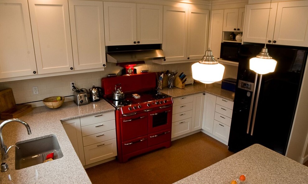 Inspiration for a small transitional u-shaped eat-in kitchen remodel in Orange County with an undermount sink, shaker cabinets, white cabinets, granite countertops, white backsplash, subway tile backsplash, colored appliances and a peninsula