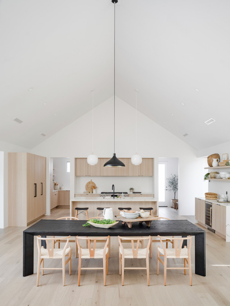 Scandi open plan dining room in Phoenix with light hardwood flooring and a vaulted ceiling.
