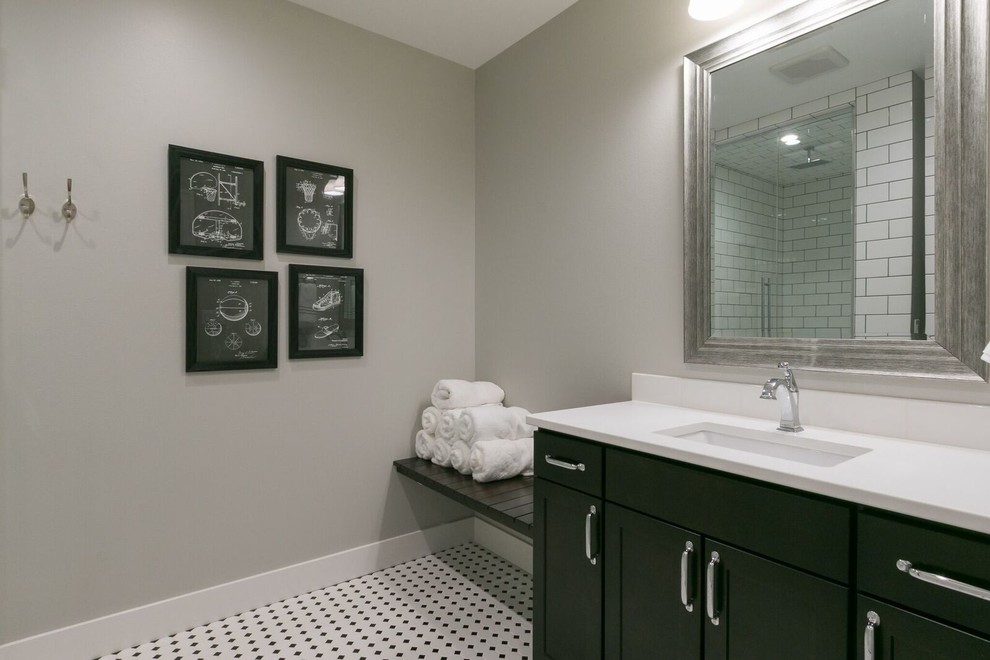 Freestanding bathtub - mid-sized transitional ceramic tile marble floor freestanding bathtub idea in Cedar Rapids with flat-panel cabinets, black cabinets, gray walls and an undermount sink