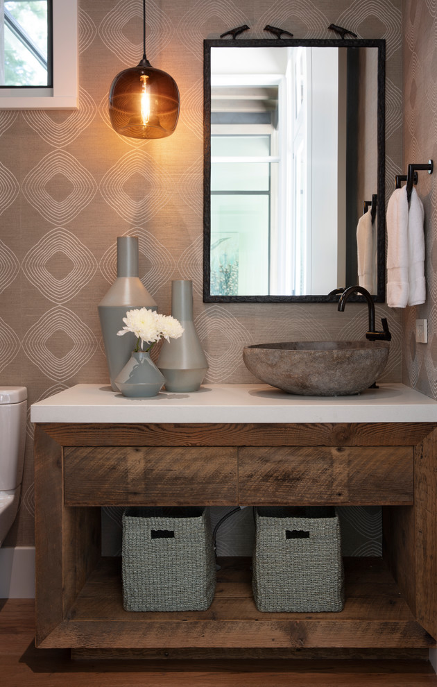 Inspiration for a contemporary powder room in Other with flat-panel cabinets, medium wood cabinets, grey walls, medium hardwood floors, a vessel sink, brown floor and white benchtops.