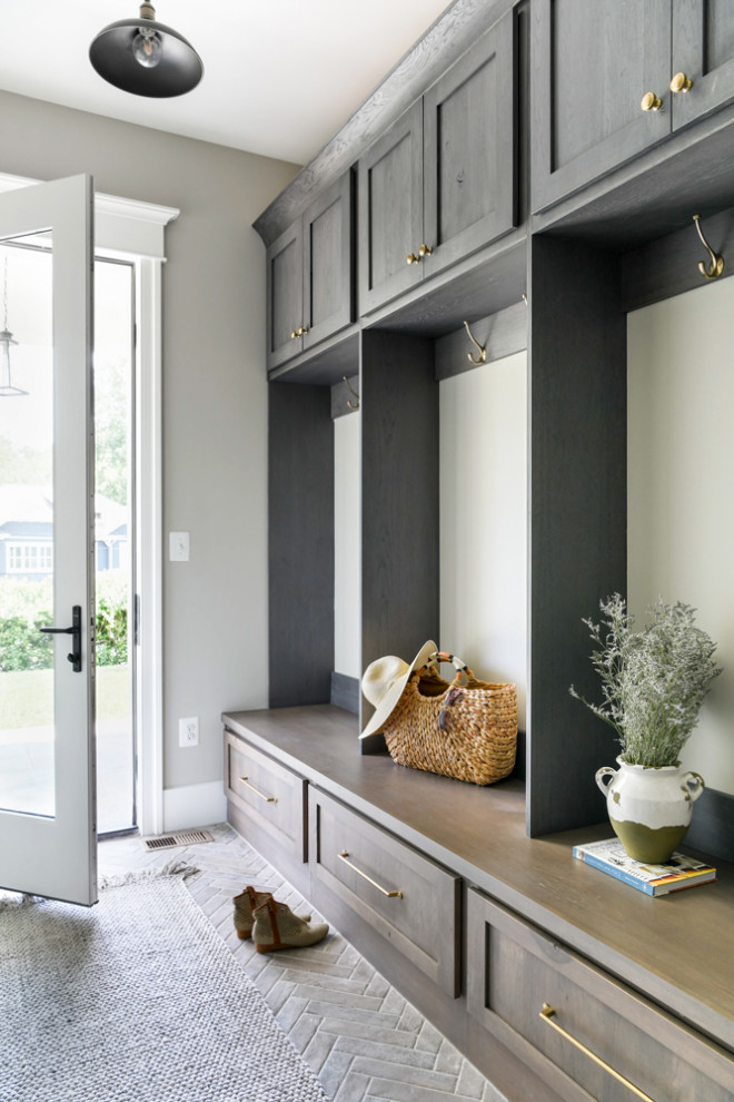 Inspiration for a mid-sized country mudroom in Other with grey walls, a single front door and a dark wood front door.