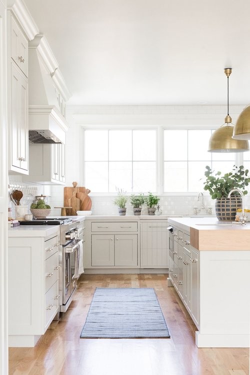 This is an example of a large country galley eat-in kitchen in Salt Lake City with beige cabinets, white splashback, subway tile splashback, medium hardwood floors and with island.