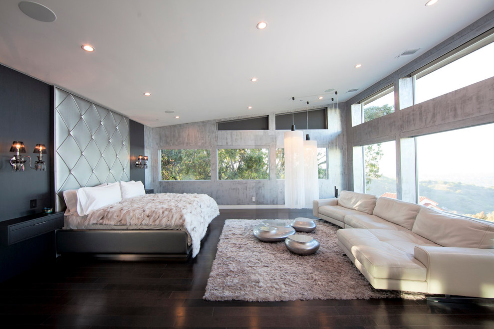 This is an example of a modern bedroom in Los Angeles with grey walls and dark hardwood floors.