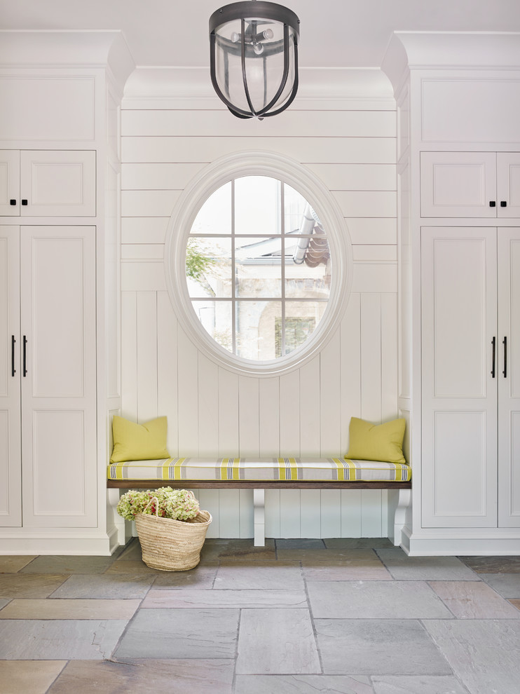 This is an example of a beach style mudroom in Atlanta with white walls.