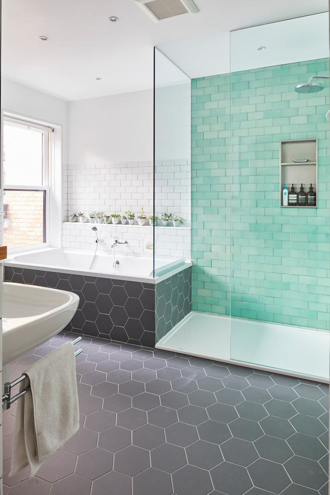Large scandinavian master bathroom in Toronto with a drop-in tub, a curbless shower, a wall-mount toilet, green tile, subway tile, white walls, ceramic floors, a wall-mount sink, grey floor and an open shower.