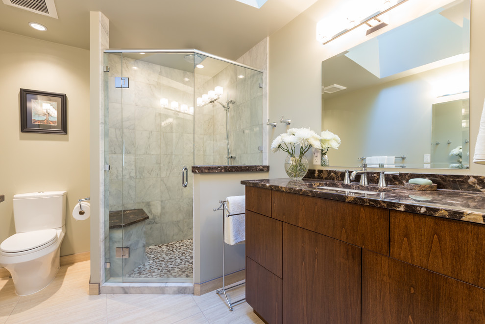 Photo of a mid-sized contemporary master bathroom in Vancouver with an undermount sink, flat-panel cabinets, medium wood cabinets, marble benchtops, a corner shower, a two-piece toilet, gray tile, stone tile, green walls and porcelain floors.